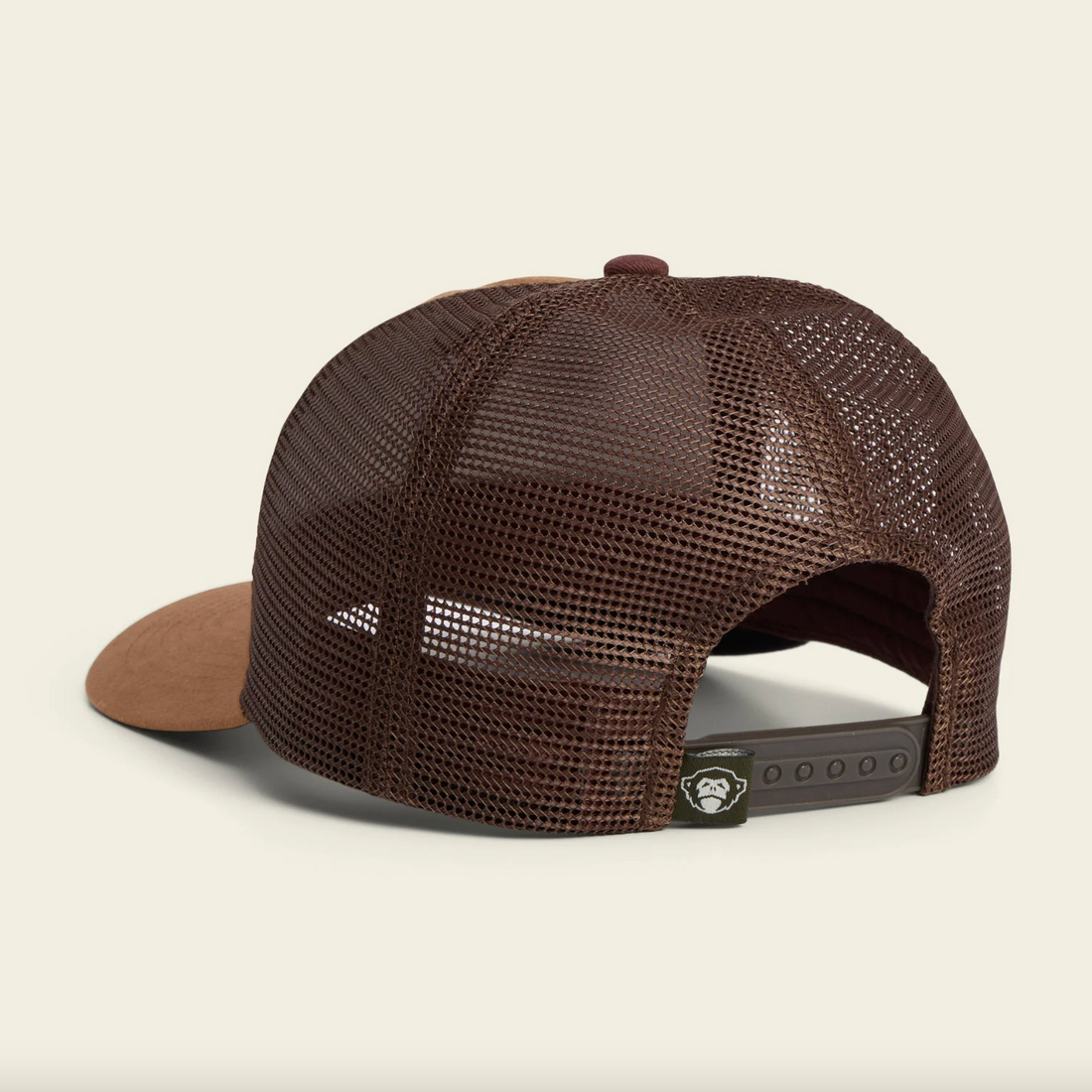Brown and black mesh cap with 'Howler' logo on a beige background