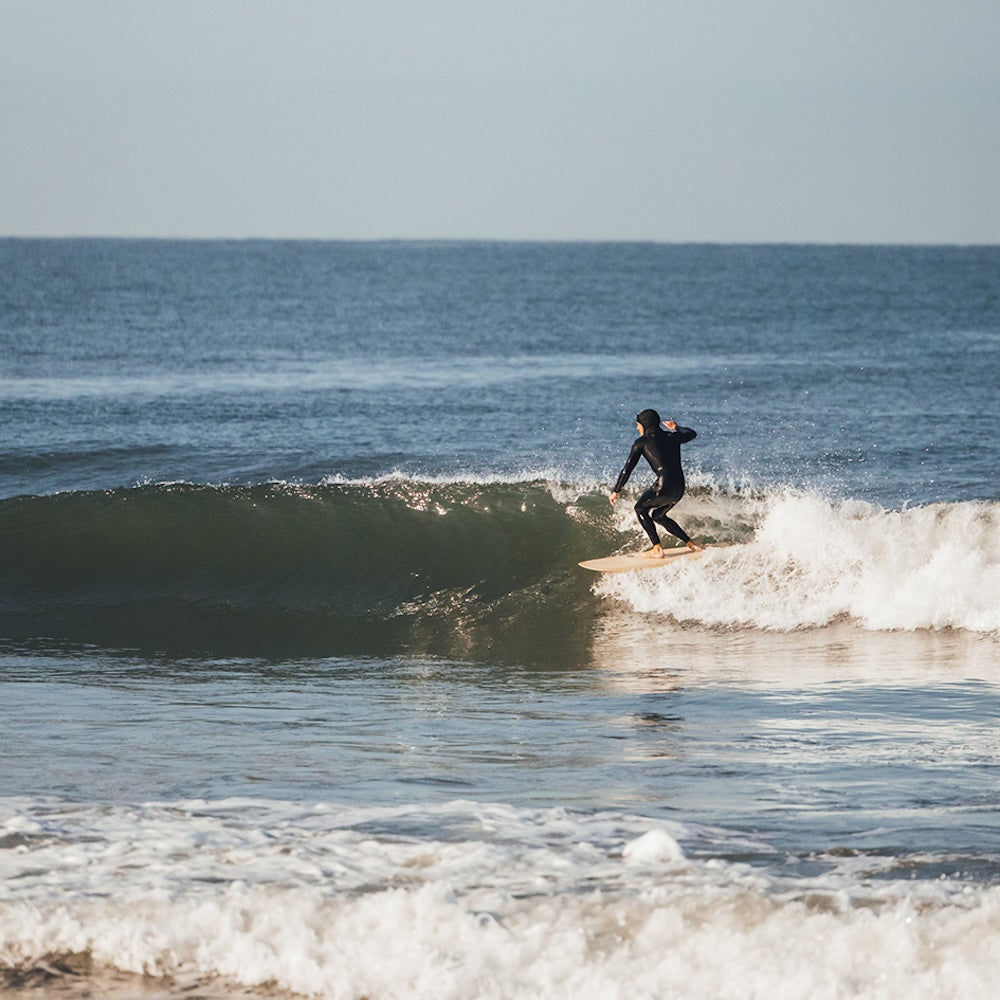 Person surfing on a wave in the ocean